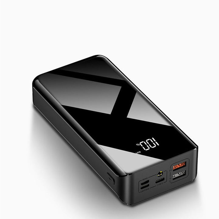 Powerbank z wyświetlaczem LCD obok telefonu